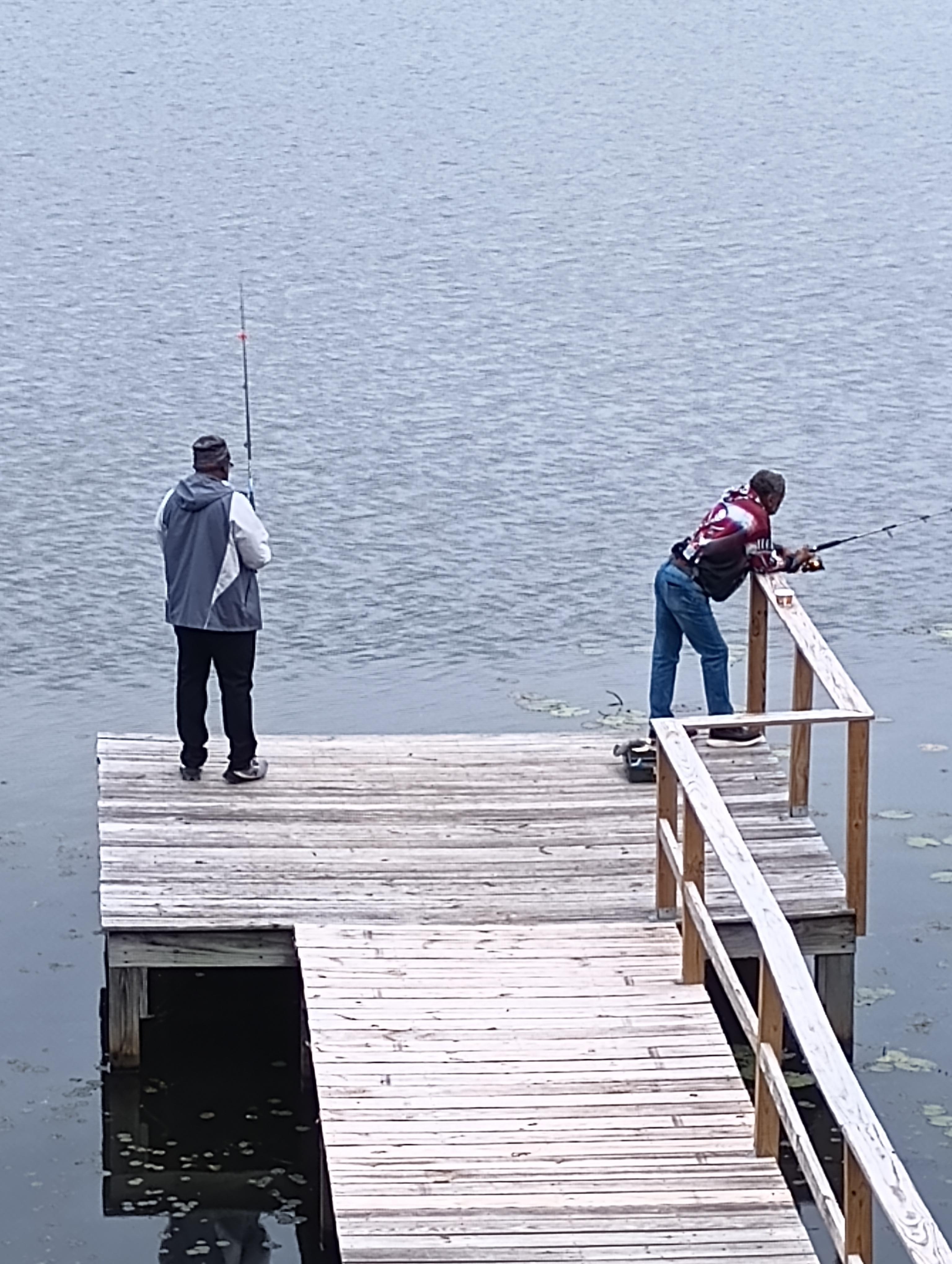 Family fishing on the dock.