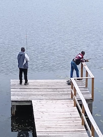 Family fishing on the dock.