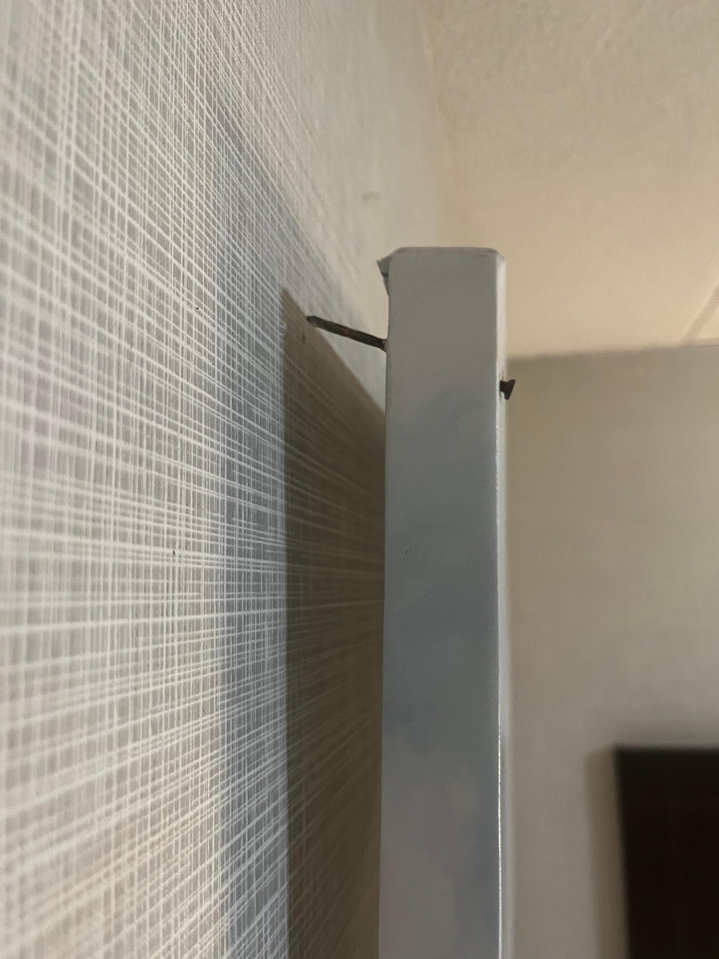 Nailed canvas falling off wall 