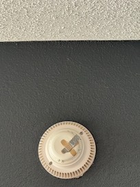 Bandaids stuck to the smoke alarm