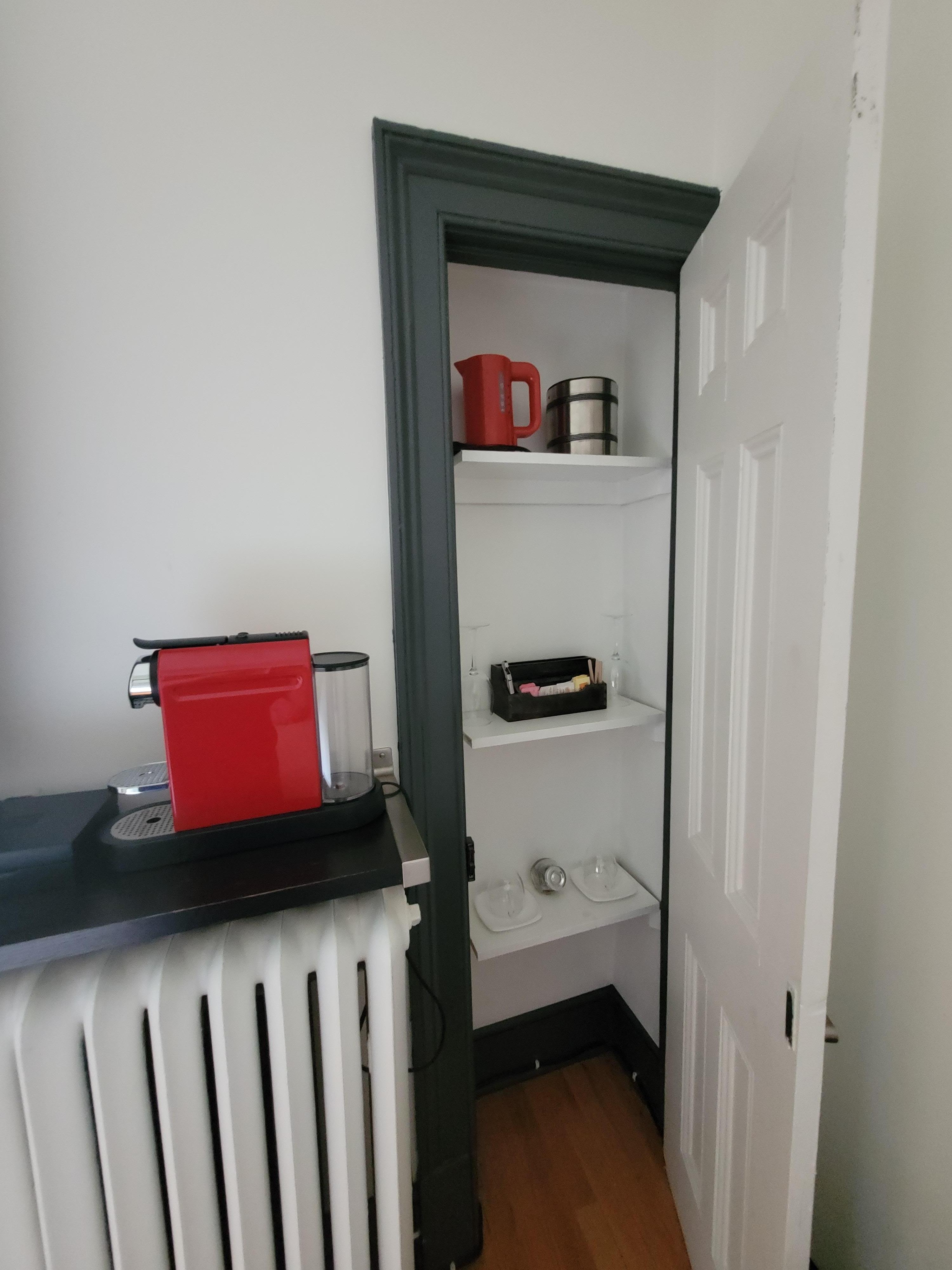 Nescaffe machine with supplies in the closet. Wine glasses, corkscrew, kettle, tea, sugar, etc, coffee cups.... robes in another closet too.