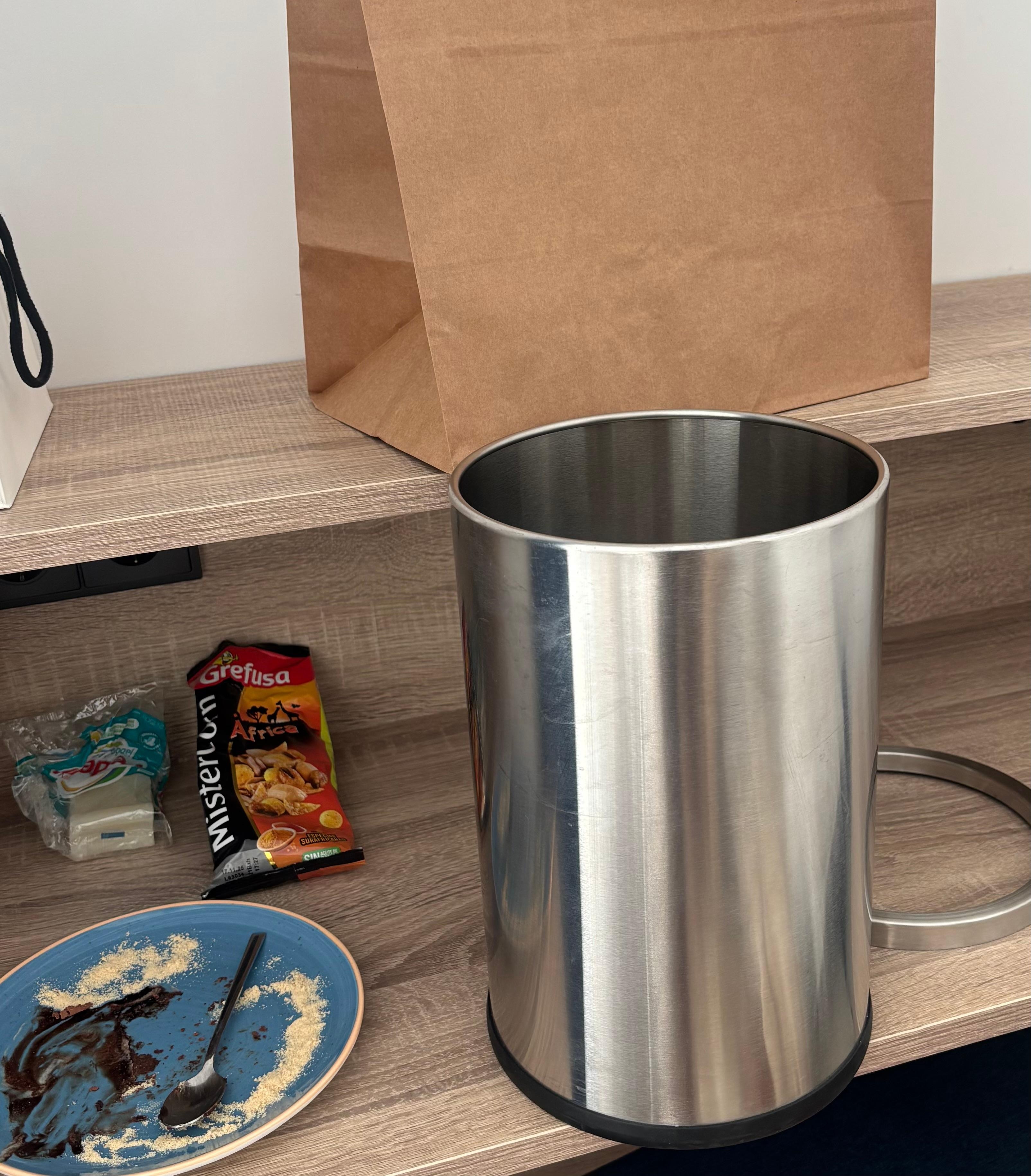 A trash can was left on the desk without a trash bag