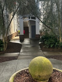 From the parking lot go through the courtyard to the stairwell closest to the street (Alexander St.)