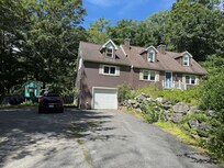 Front of house. Wide driveway