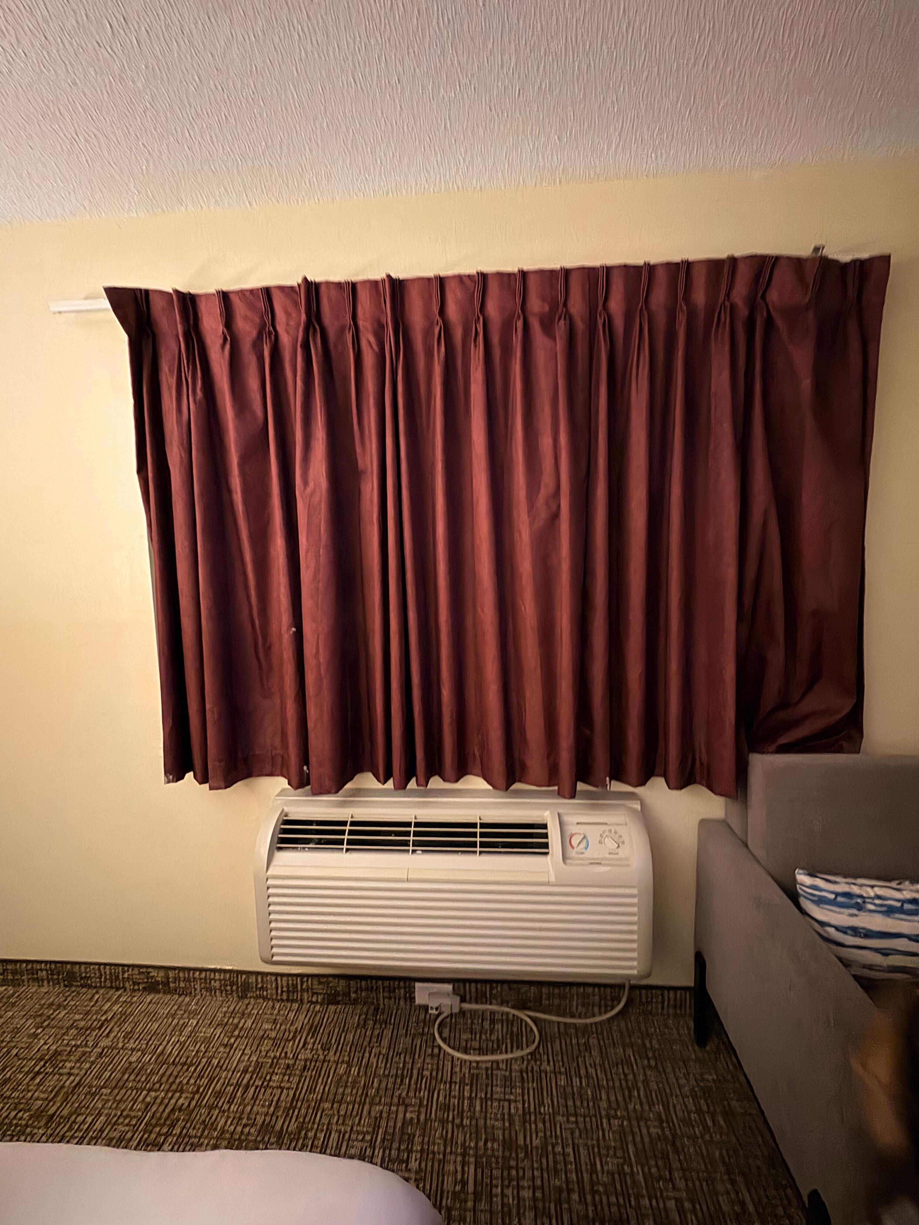 Curtain barely hanging on to window