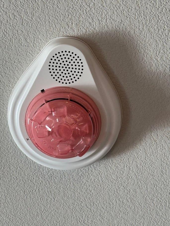 Alarm on the ceiling with a plastic cover