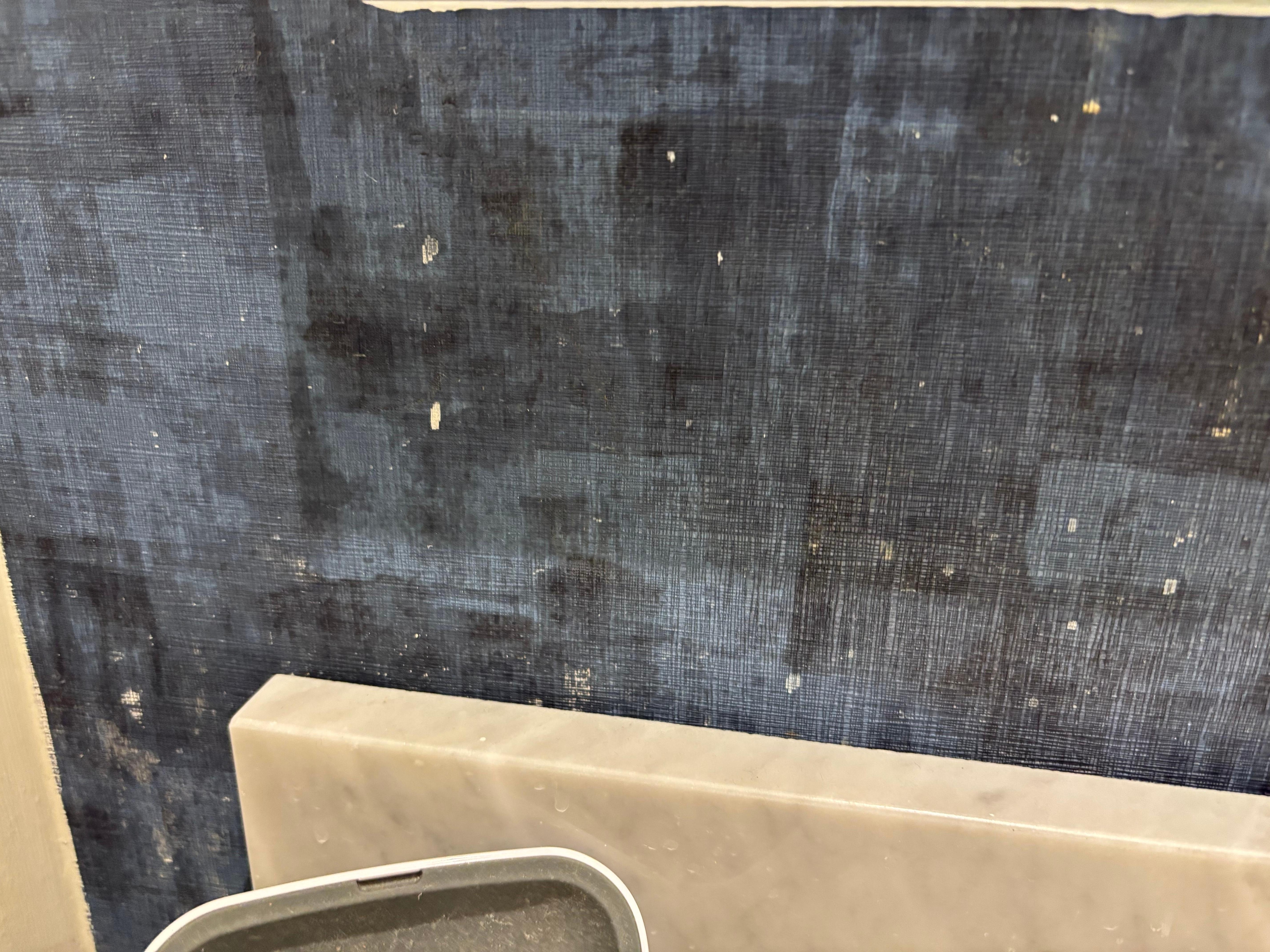 Toothpaste spit stains on bathroom wall 