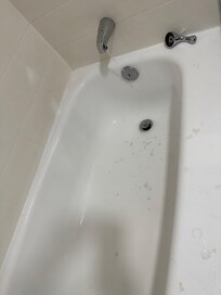 Bathroom faucet-handle was loose, water dripping after shut-off, and stub stains.