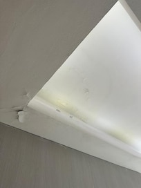 Cracked painting in bathroom ceiling