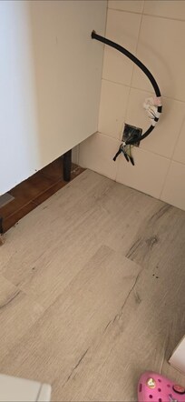 Exposed electrics and empty cavity where cooker used to be