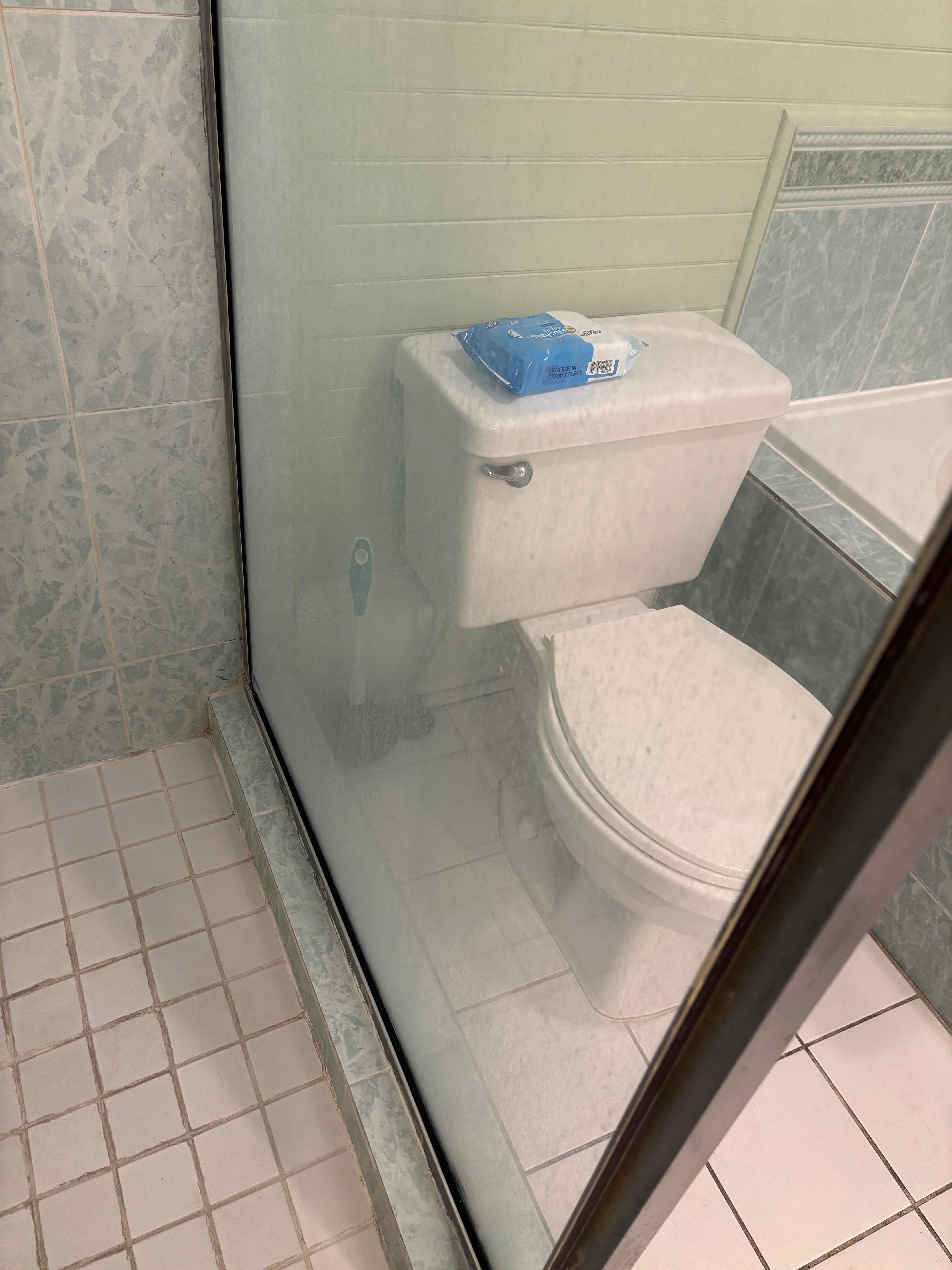 soap scum covering both glass shower walls