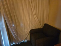 Curtains and chair placement on our entry to the room. The curtains had holes.