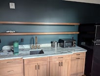 Weird empty kitchenette, guess you're supposed to drink directly from the faucet because there are not even glasses. Note the pointless ice bucket.... there is no ice here.