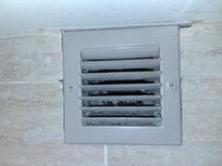 Bathroom vent grate showing evidence of poor maintenance.