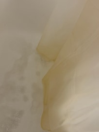 Dirty rusted shower curtain