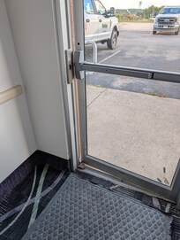 Exterior door lock broken...door held open with a rock.