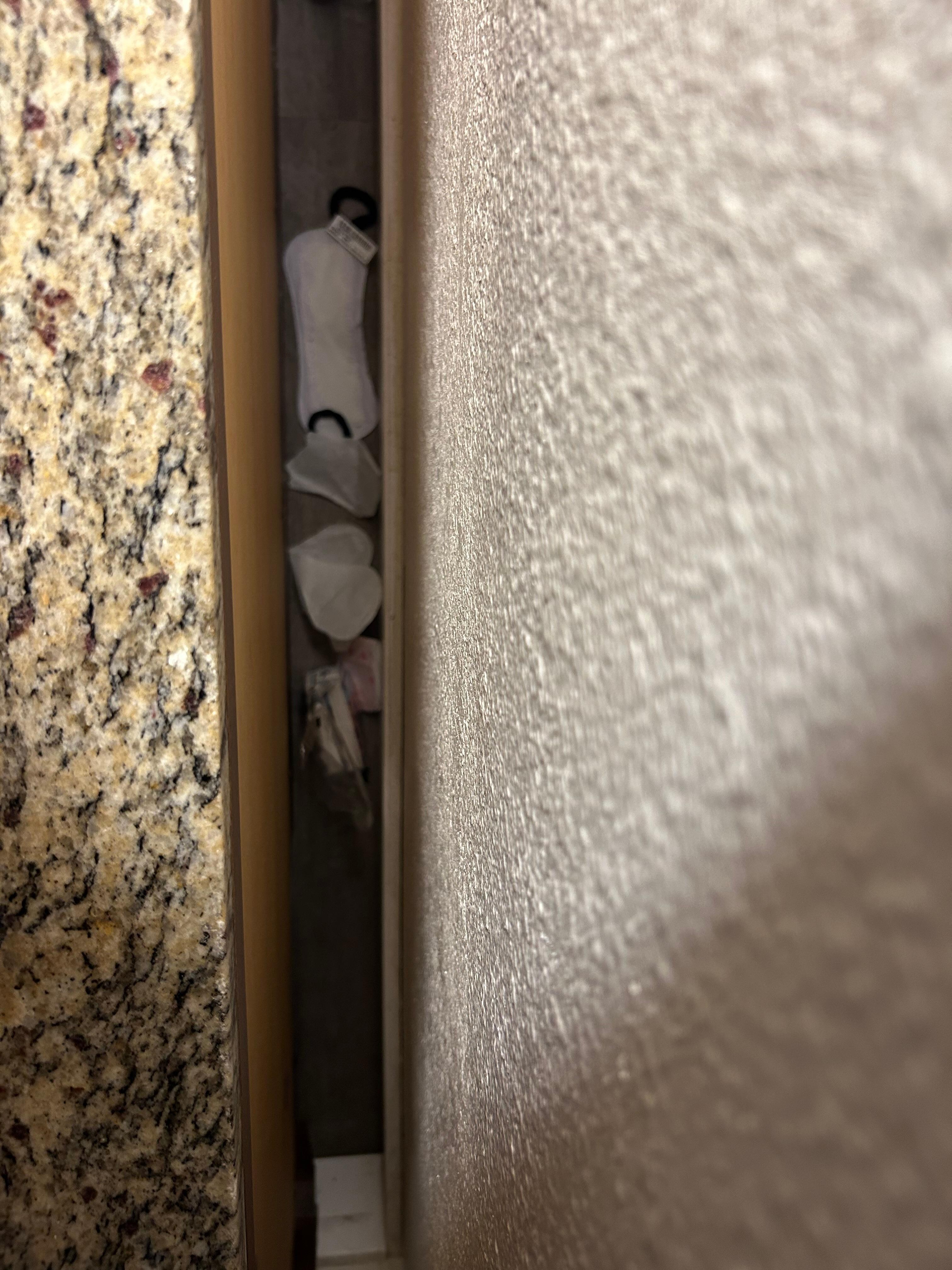 Diaper and feminine hygiene products behind dresser.