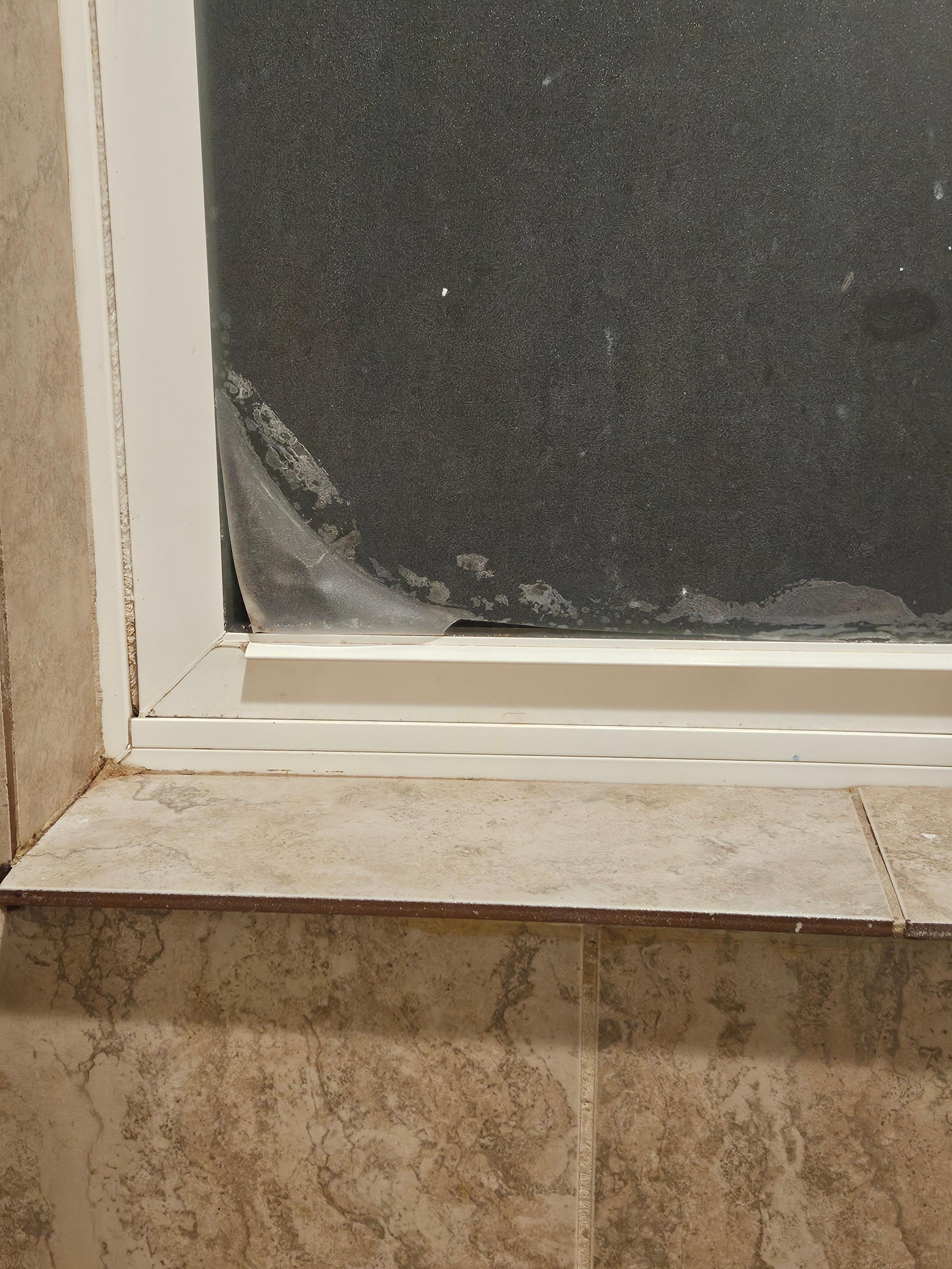 Bathroom Window inside shower, floor tile as a sill