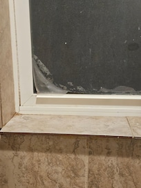 Bathroom Window inside shower, floor tile as a sill