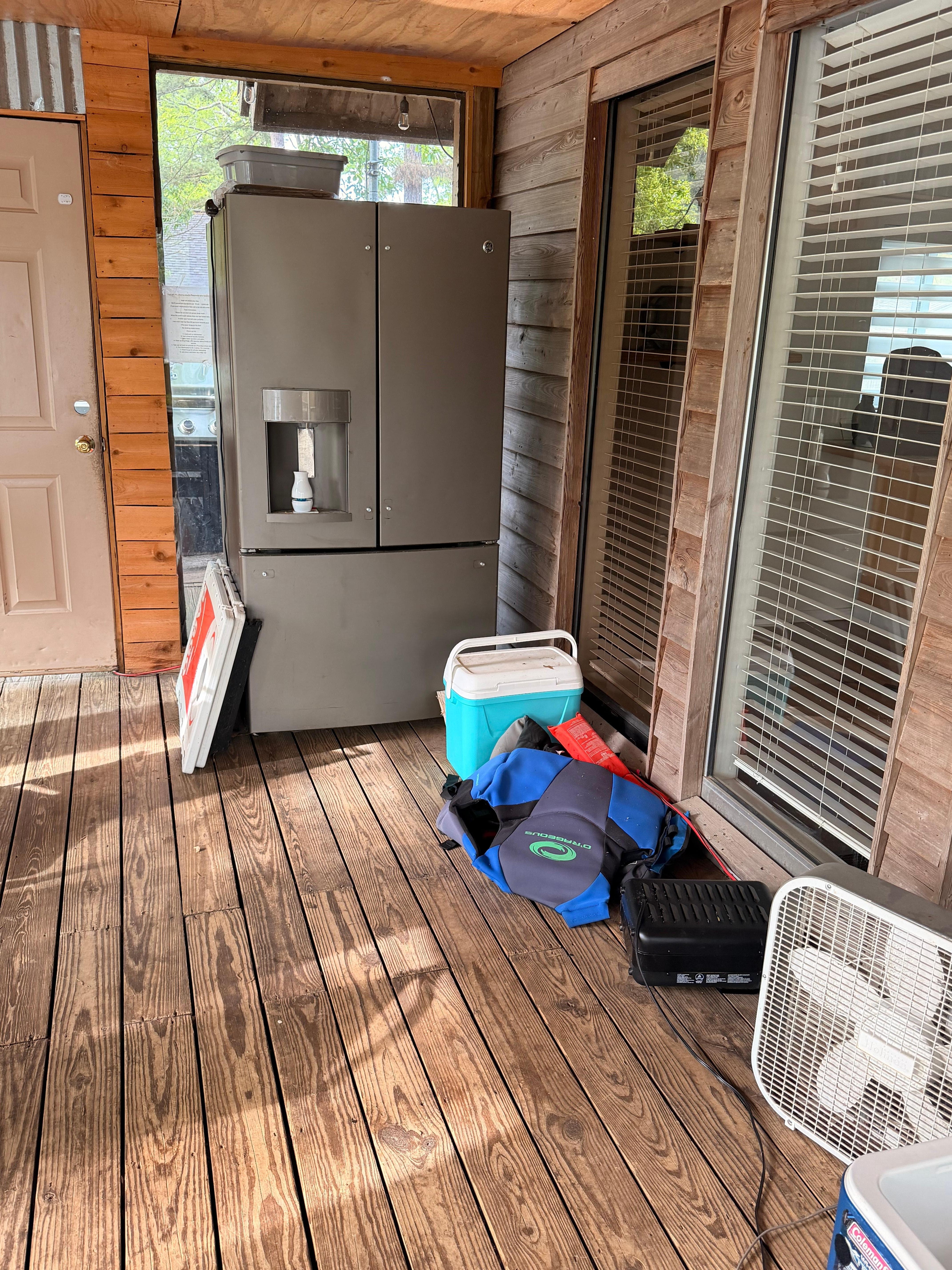 Fridge with mold unplugged in back porch.  