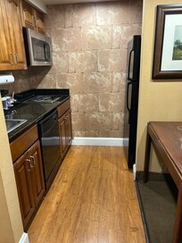 Kitchen, microwave, refrigerator, table with two chairs,