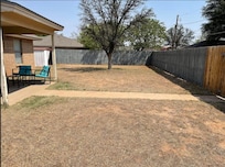 The bare back yard - zoom in and you can see the granuals of white fertilizer all over the ground. Ants were all over the yard/tree/patio.
