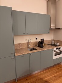 Well outfitted kitchenette with plenty of dishes and glasses.