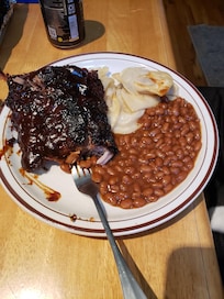 Bbq back ribs on the grill with progies and onions on the grill. Baked beans for our anniversary dinner.