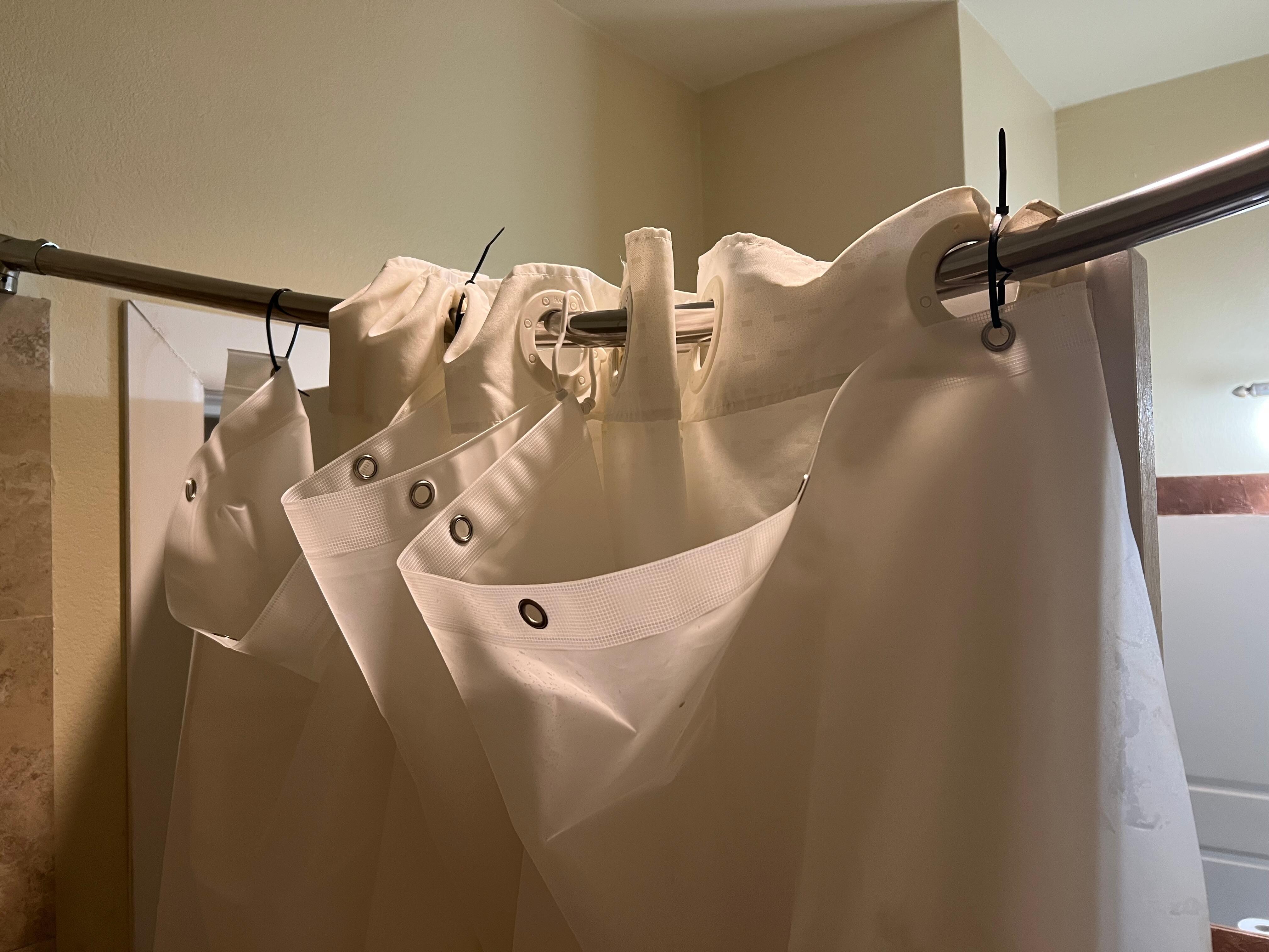 Zip ties to hold up the pitiful shower curtain.