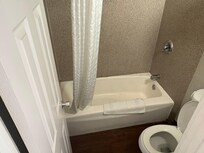 Stained toilet, bathtub and walls