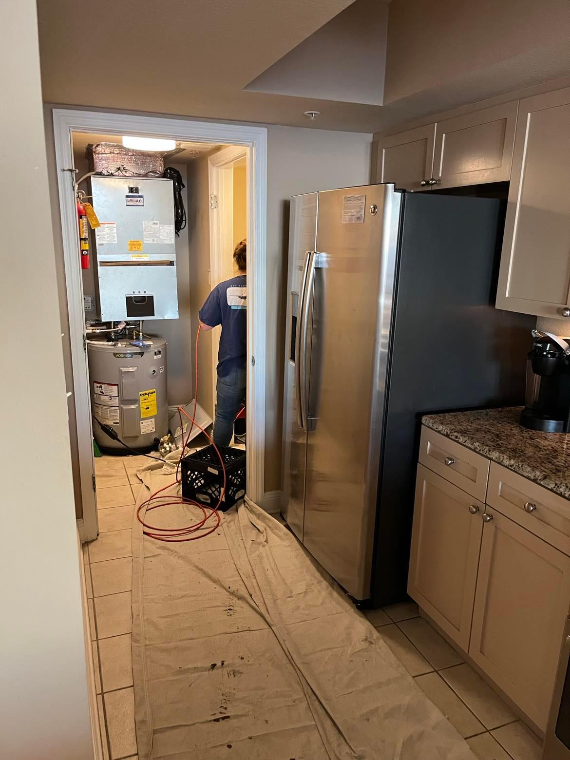 drop cloth in kitchen and workers in laundry room