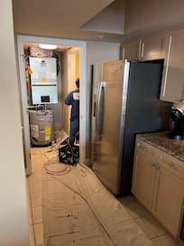 drop cloth in kitchen and workers in laundry room