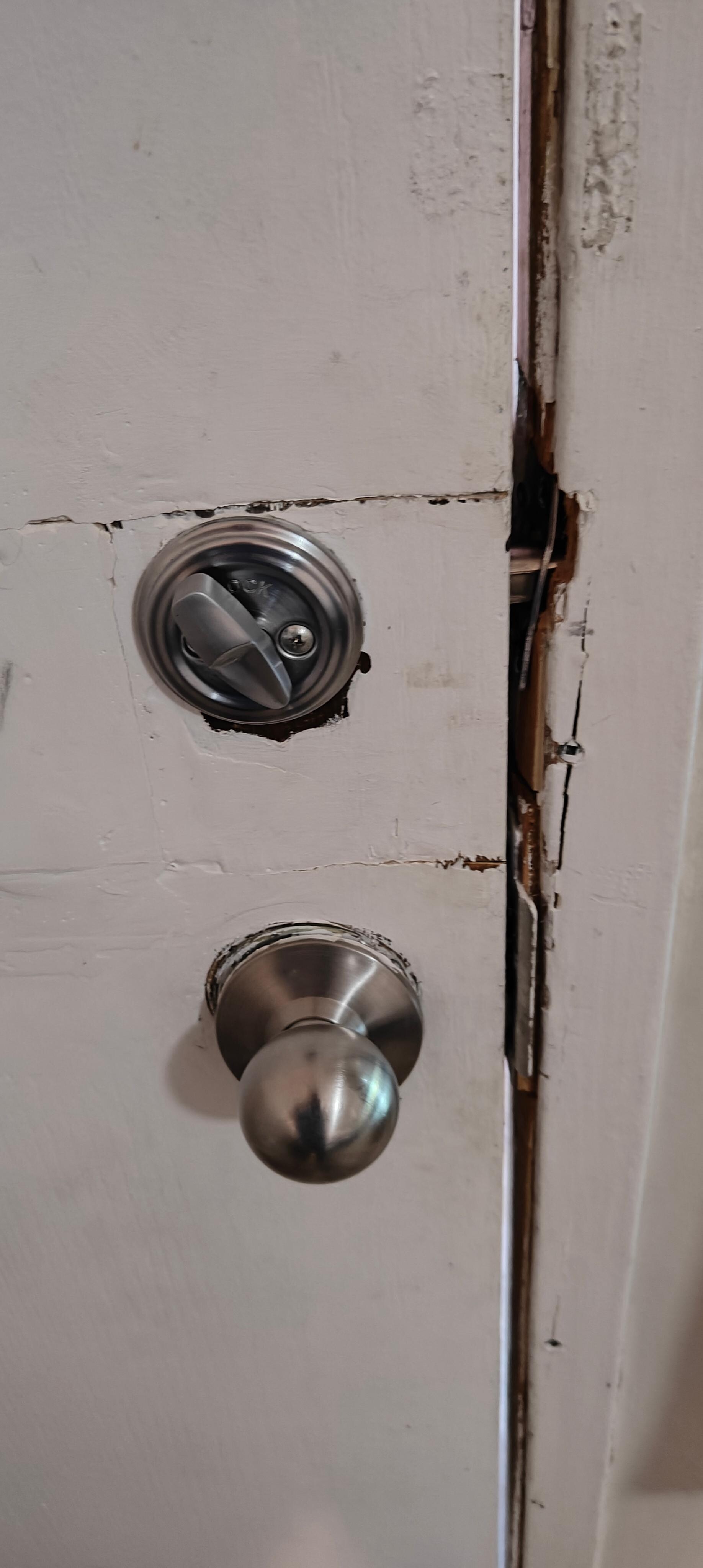 Door had been kicked in at some time and this is the rudimentary repairs. Still locked however.