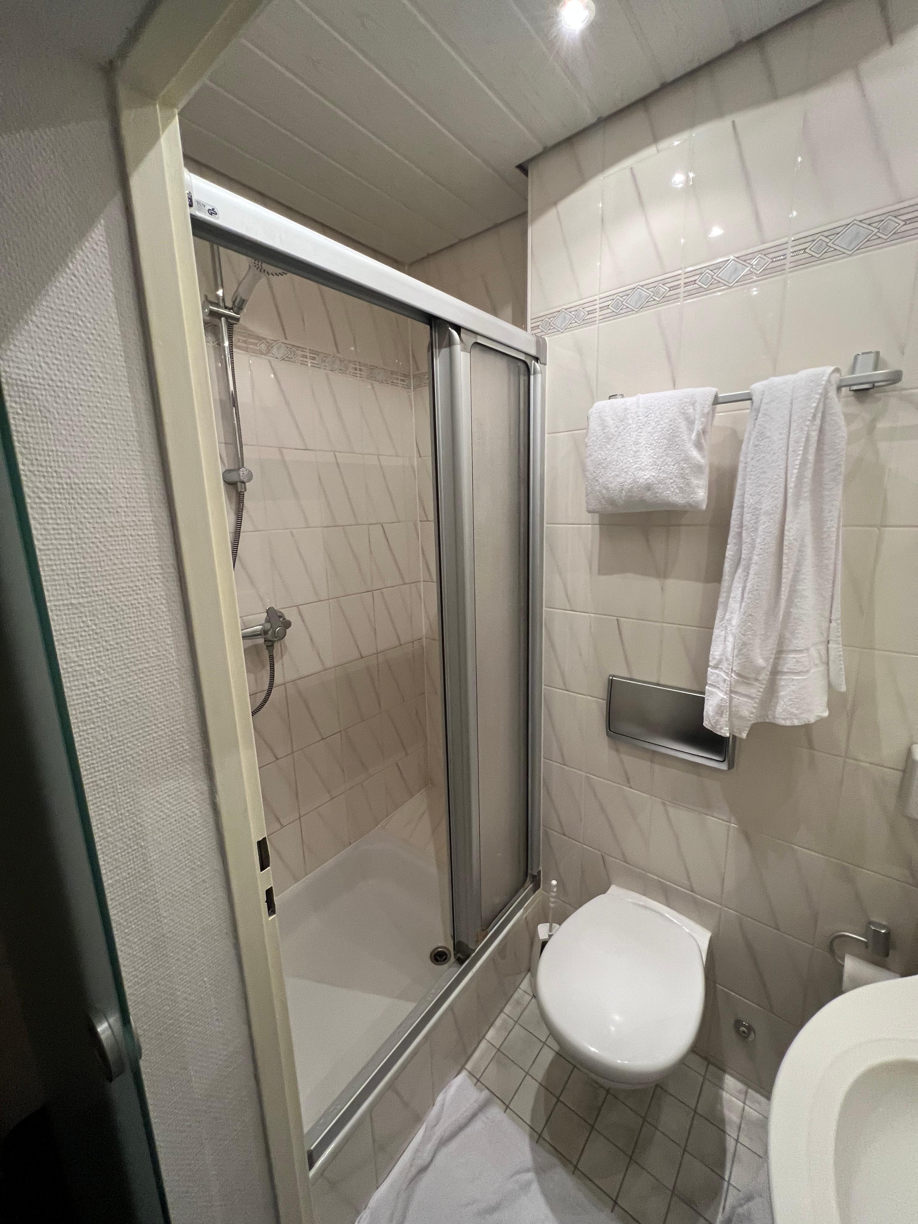 The shower is a good size, clean and fully functional.