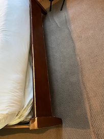 Dirty carpet is coming up and bed frame is worn