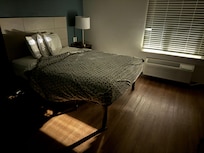 As dark as the room could get prior to 2am when the spotlight on the roof shut off. Note the paper-thin blanket.