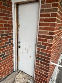 Bedroom door that leads to upper deck; The towel in front of the door is full of animal poop.