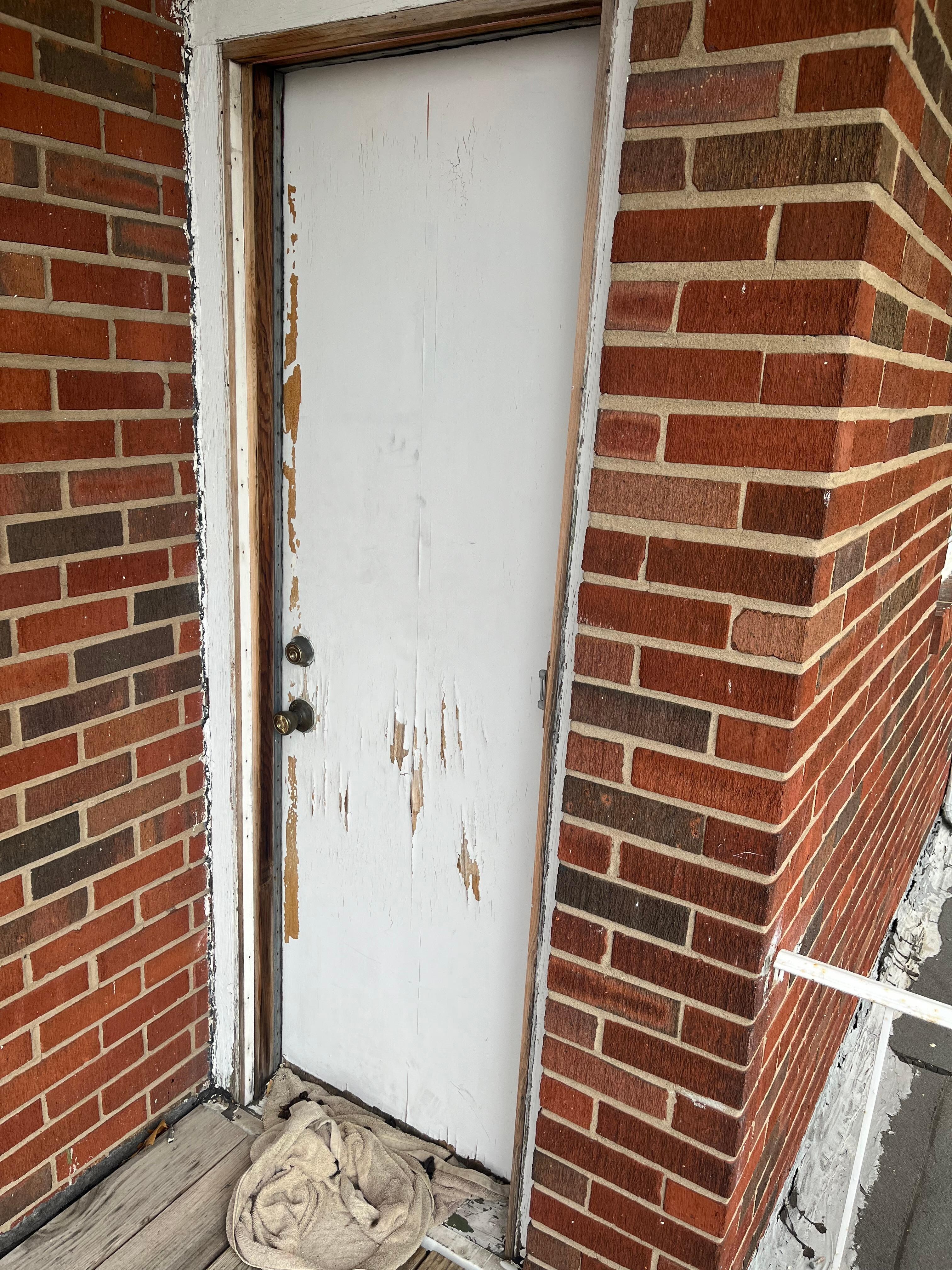 Bedroom door that leads to upper deck; The towel in front of the door is full of animal poop.