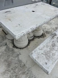Heavy concrete table. Old and crumbling.