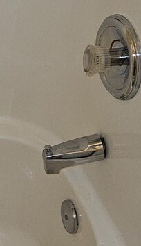 Tub spout away from wall and aimed down and left. Plus pop-up on drain wasn't attached
