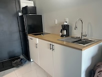 Kitchen with full fridge and built-in 2 burner stove