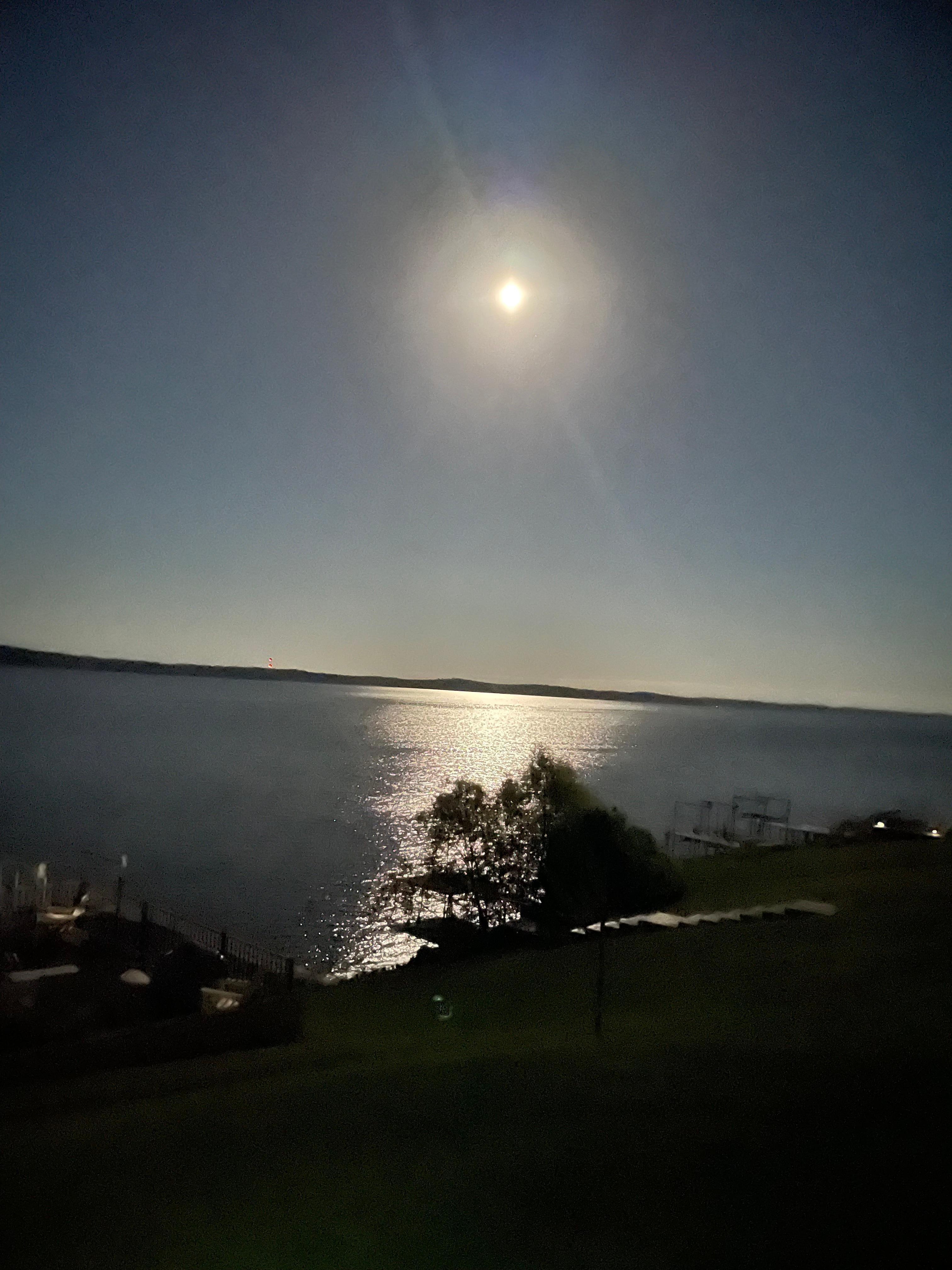 Full moon reflects off the lake.  View from the patio.
