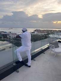 Watching the see unset on roof top bar.