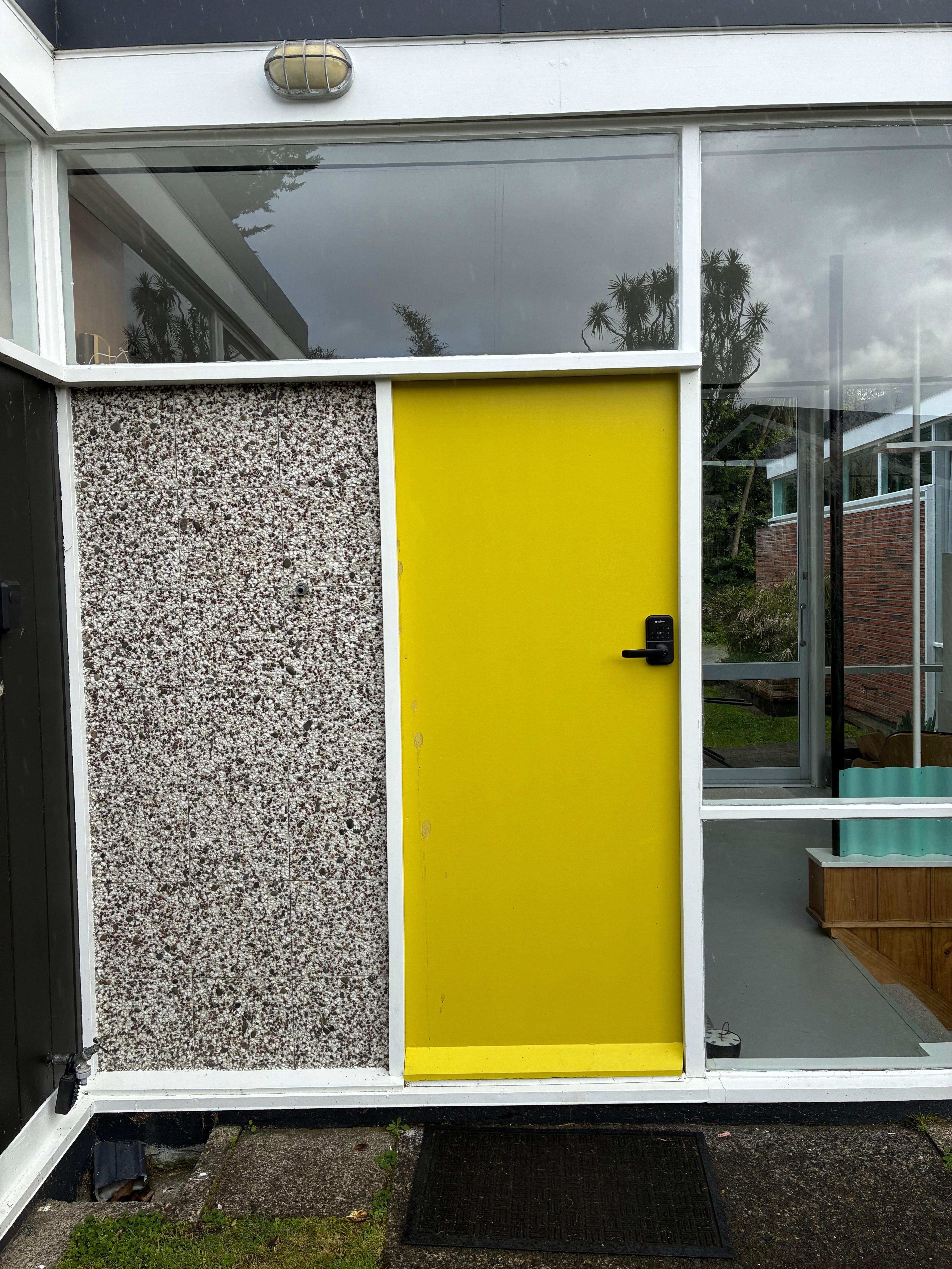 The pebble wall and front door