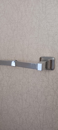 Towel bar behind bathroom door