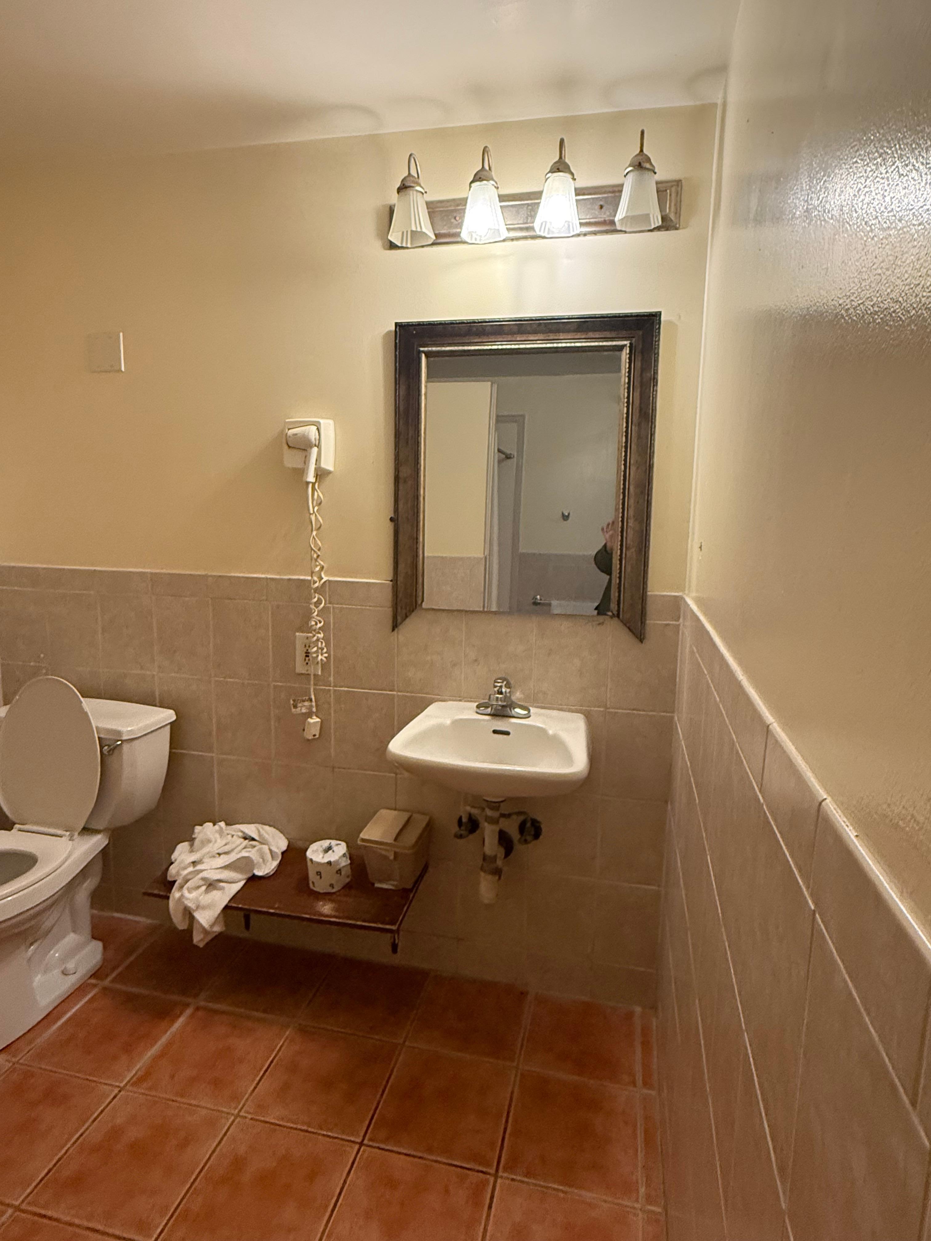 Toilet wasn’t attached properly to floor and moved around.  Bottom of mirror missing and hair dryer didn’t work.