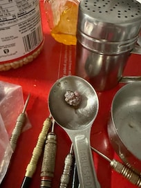 This is the top of the filthy popcorn machine in the movie theater. Something was growing in the dirty measuring spoon with all the darts for the dart board.