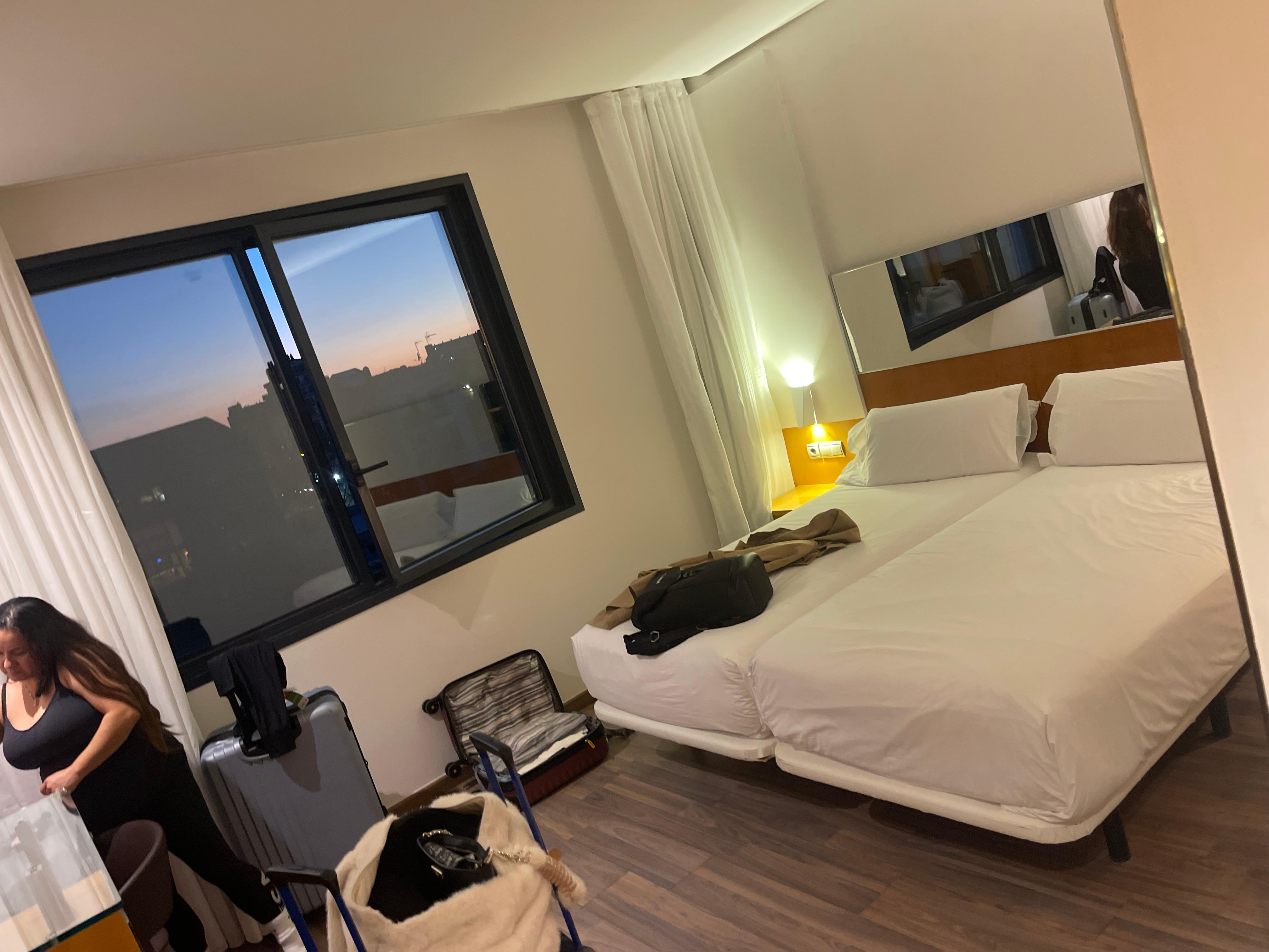 Bedroom view with Double Beds overlooking the pool & gym.