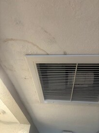 Water stains and water was dripping in the walkway from ceiling.