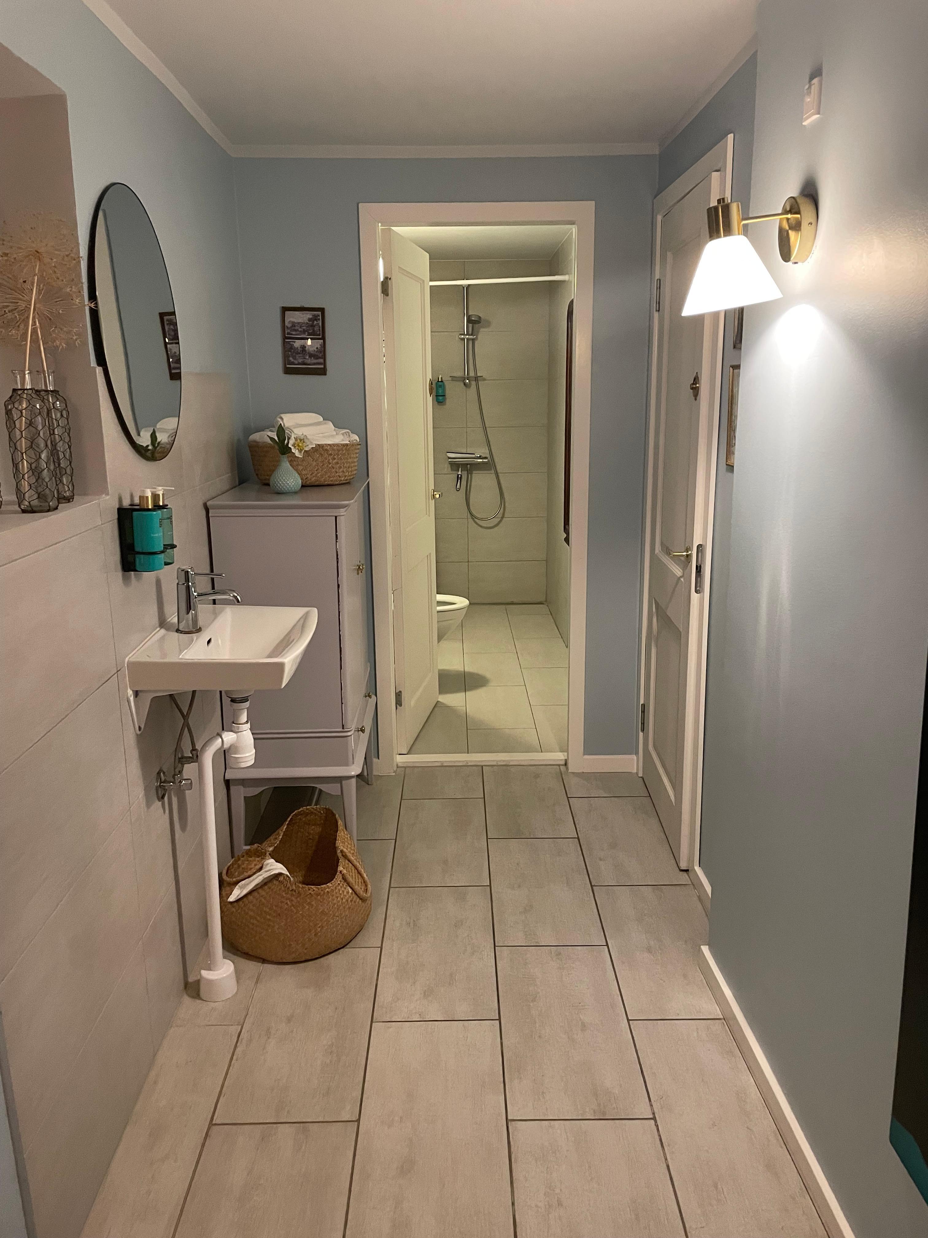 The shower at the end of the restaurant toilet. (The basket beside the sink was overflowing with dirty towels that stayed overnight, and were still there when we went to shower the next AM.